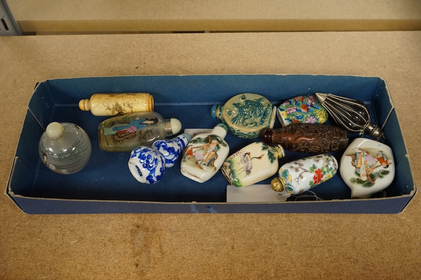 A group of Chinese snuff bottles to include porcelain, bone, enamelled, glass and amber examples, tallest 8cm. Condition - varies